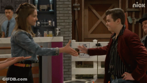 Man In Red Jacket Shaking Hands With Girl In Denim GIF