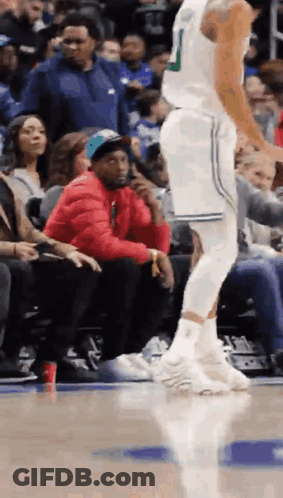 Man In Red Jacket Sitting At Basketball Game GIF