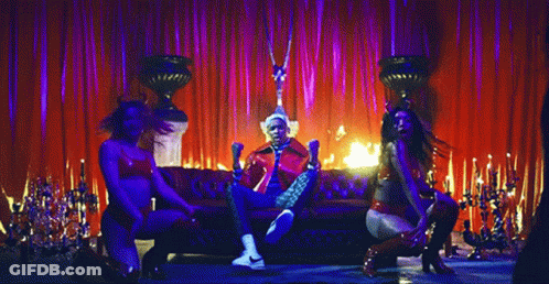 Man In Red Jacket Sitting By Fire GIF