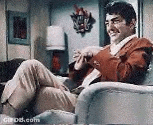 Man In Red Jacket Sitting Crossed Legs GIF