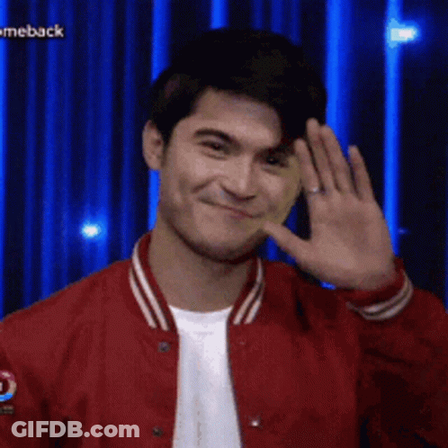 Man In Red Jacket Smiling And Waving GIF