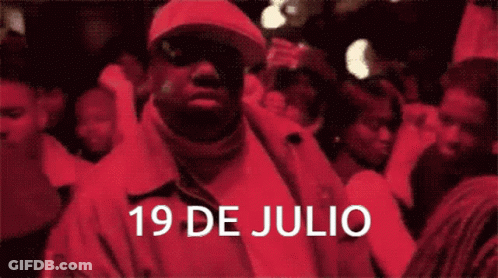 Man In Red Jacket Standing In Front Of Crowd GIF