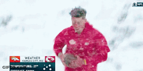 Man In Red Jacket Standing In Snow With Kansas City NFL Weather Sign GIF