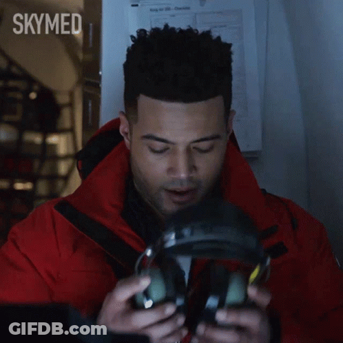 Man In Red Jacket Talking Into Microphone With Skymed GIF