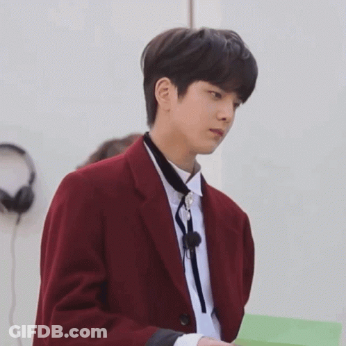 Man In Red Jacket Tie Holding Green Paper GIF