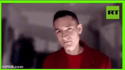 Man In Red Jacket With Green Frame GIF