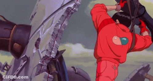 Man In Red Jacket With Heart On Back Standing In Front Of Broken Wall GIF