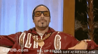 Man In Red Jacket With Letter G Arms Outstretched On Couch GIF