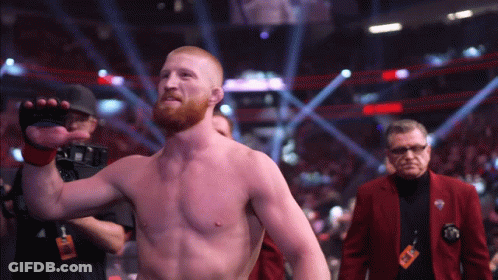 Man In Red Jacket With UFC Lanyard GIF