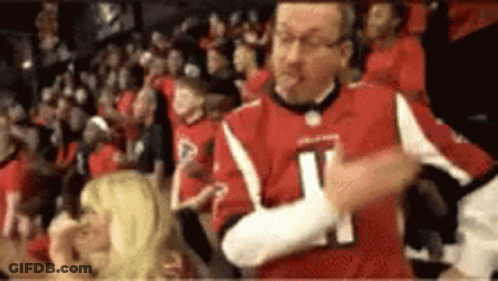 Man In Red Jersey Number 21 Dancing In Crowd GIF