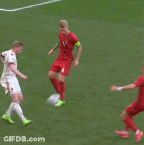 Man In Red Jersey Number 4 Kicks Soccer Ball GIF