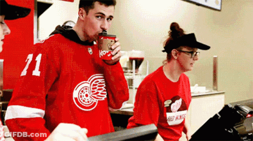 Man In Red Jersey Number 71 Drinking Coffee GIF