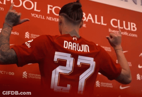 Man In Red Jersey With Darwin On Back GIF
