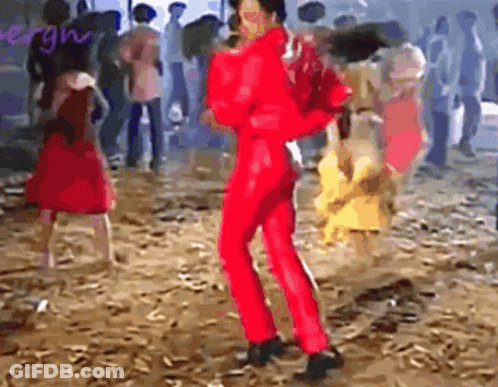 Man In Red Jumpsuit Dancing In Front Of Crowd GIF