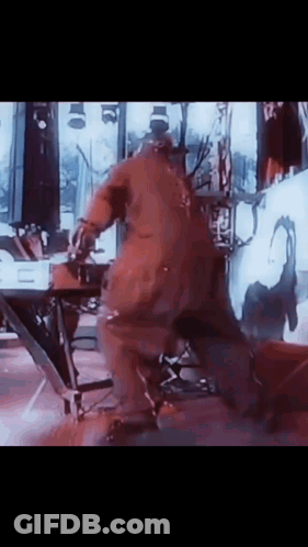 Man In Red Jumpsuit Dancing On Stage GIF