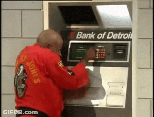 Man In Red Karate Uniform Using Bank Of Detroit ATM GIF