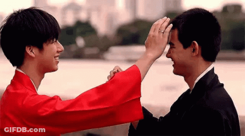 Man In Red Kimono Touching Another Man's Forehead GIF