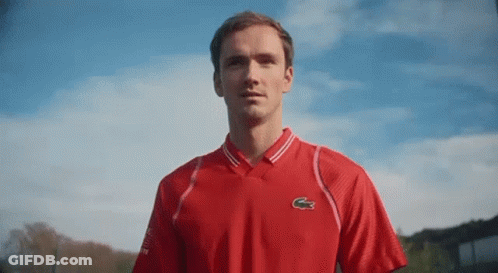 Man In Red Lacoste Shirt Against Blue Sky GIF