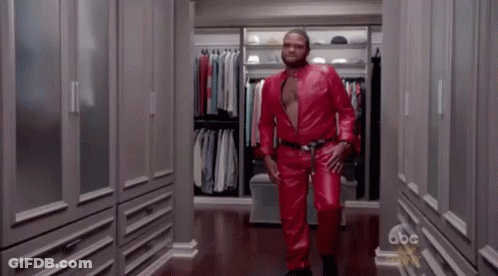 Man In Red Leather Suit Walking Down Closet GIF