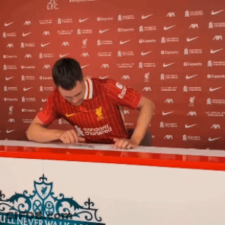 Man In Red Liverpool Jersey Signing Paper GIF