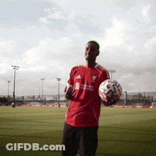 Man In Red Liverpool Shirt Holding Soccer Ball GIF