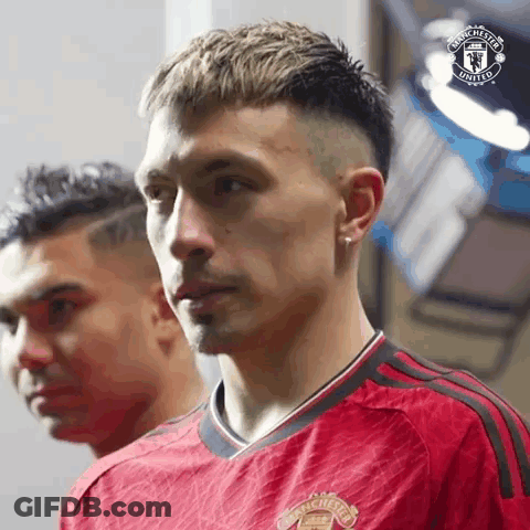 Man In Red Manchester United Jersey Beside Man In Black Shirt GIF