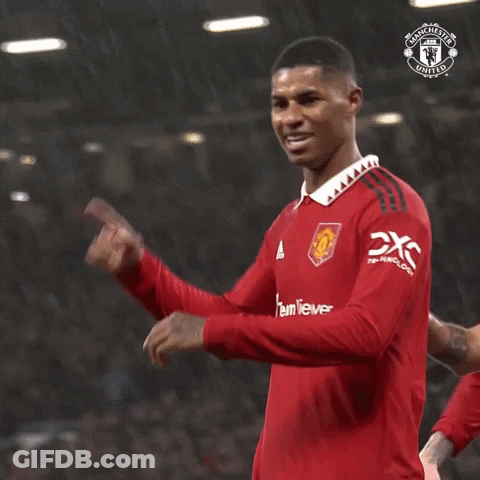 Man In Red Manchester United Jersey Holding Finger To Head GIF