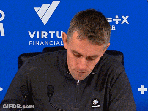 Man In Red Manchester United Jersey Next To Table GIF