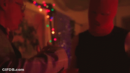 Man In Red Mask Next To Man In Black Tank Top GIF