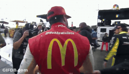 Man In Red McDonald's Vest In Front Of Crowd GIF