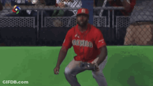 Man In Red Mexico Jersey In Front Of Fence GIF