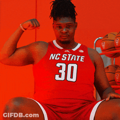 Man In Red NC State Jersey Flexing Arm GIF