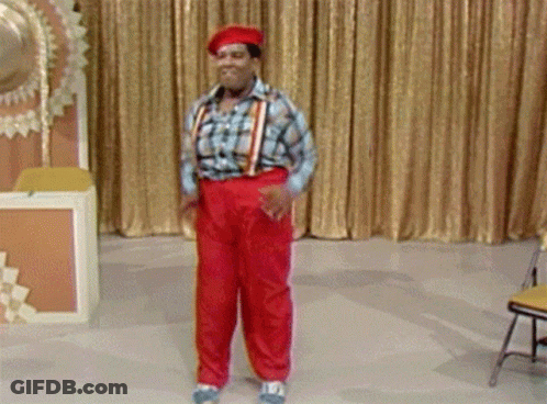 Man In Red Pants And Suspenders Before Gold Curtain GIF