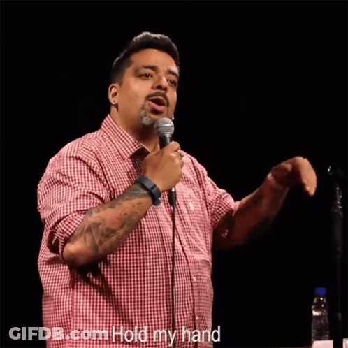 Man In Red Plaid Shirt Holding Microphone Saying Hold My Hand GIF