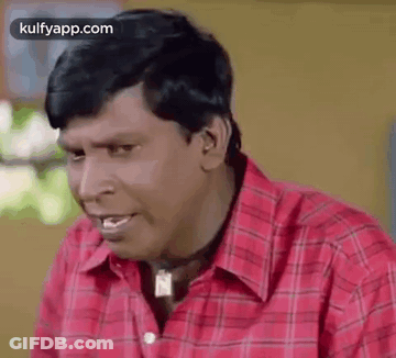 Man In Red Plaid Shirt Making Funny Face With Necklace GIF