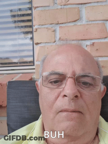 Man In Red Plaid Shirt Smiling In Front Of TamilChatroom.in Logo GIF