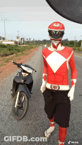 Man In Red Power Ranger Costume Next To Motorcycle GIF