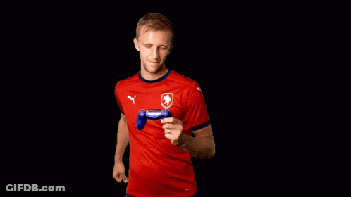 Man In Red Puma Shirt Holding Controller GIF