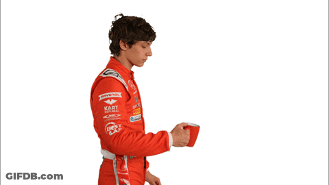 Man In Red Racing Suit Drinking From Red Container GIF