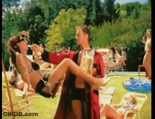 Man In Red Robe Carrying Woman In Bikini GIF
