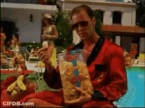 Man In Red Robe Holding Bag Of Doritos Chips GIF