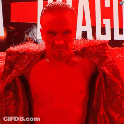 Man In Red Robe In Front Of League Sign GIF