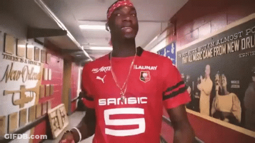 Man In Red Sansic Shirt Standing In Hallway GIF