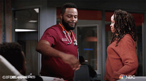 Man In Red Scrub Talking To Woman In Red Sweater #Chicagomed GIF
