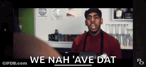 Man In Red Shirt And Apron Talking At Bar GIF