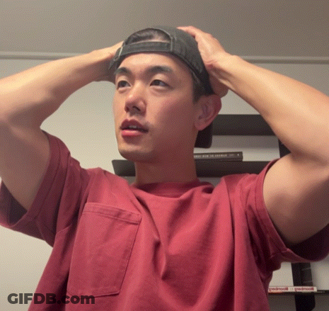Man In Red Shirt And Black Hat Adjusting Hat GIF