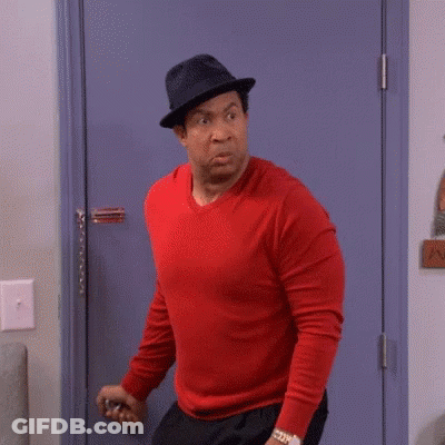 Man In Red Shirt And Black Hat At Blue Door GIF