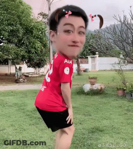 Man In Red Shirt And Black Shorts In Grass GIF
