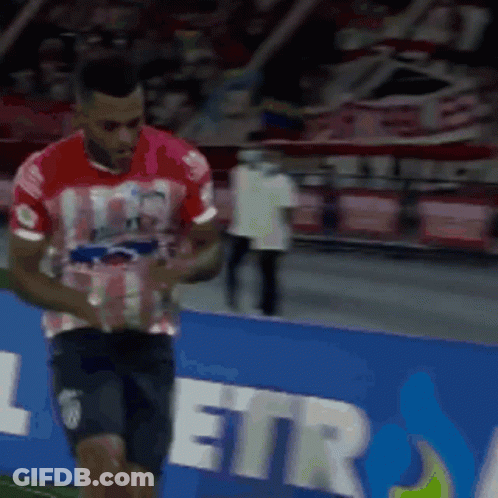 Man In Red Shirt And Black Shorts On Soccer Field GIF