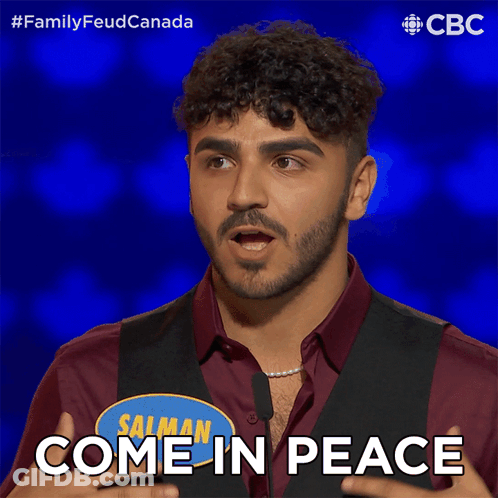 Man In Red Shirt And Black Vest Says Come In Peace GIF